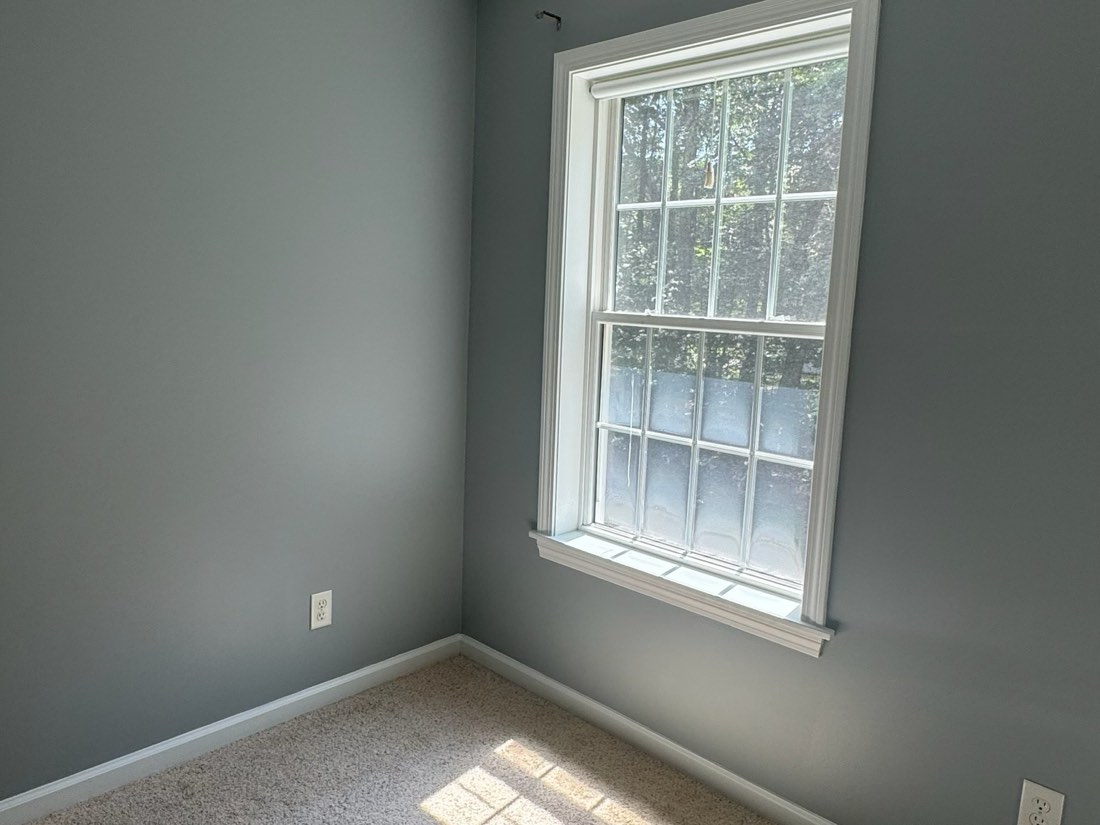 Bedroom repainted in a soft grey with white trim