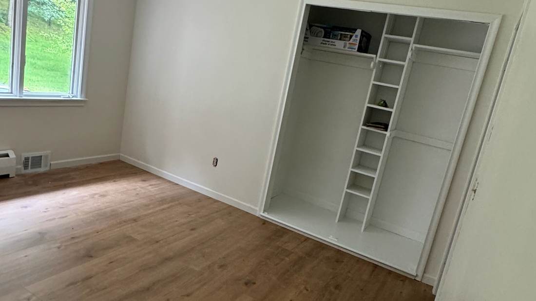 Laminate planks being fitted along a wall